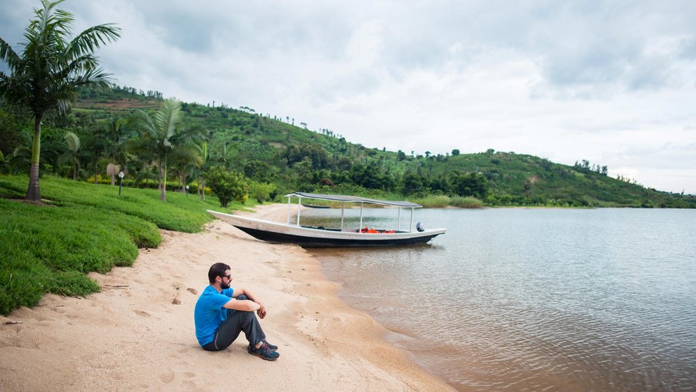 Ein Mann sitzt am Ufer des Lake Kivu